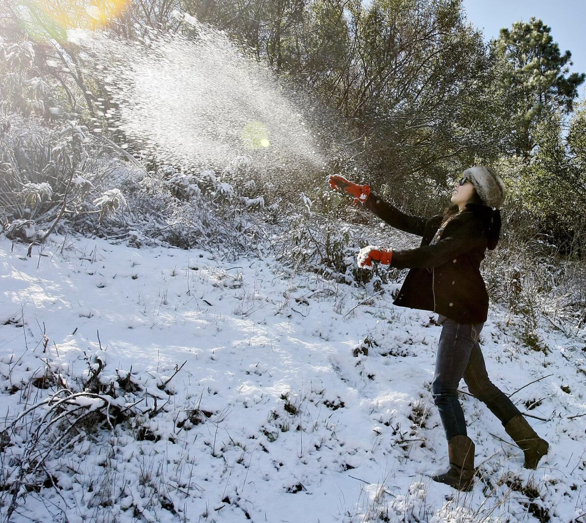 Katia Guerrero, 17 from Monrovia, plays in the snow at Angeles Crest Highway near Angeles Forest Highway in the Angeles National Forest above La Canada Flintridge on Wednesday, February 20, 2013. Guerrero's older sister brought her up to the snow because today is her birthday. A fast-moving storm dumped snow at higher elevations overnight.