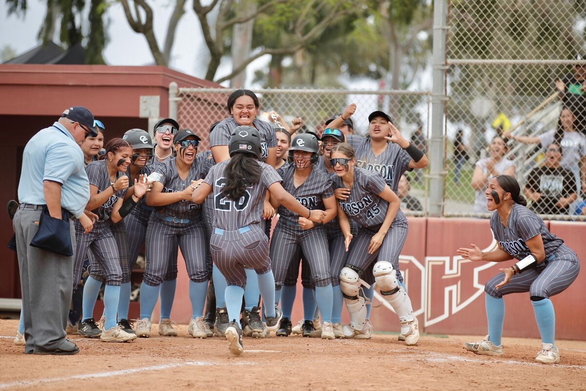 Carson High's Rylee Gardner (26) is congratulated at home plate by her teammates after her home run in the third inning.