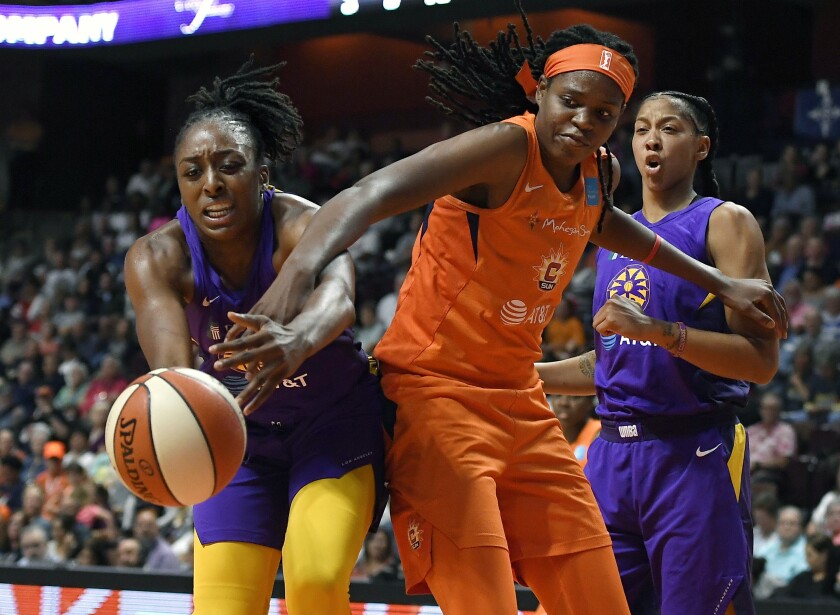Sparks forward Nneka Ogwumike, left, and Connecticut’s Jonquel Jones battle for the ball during Game 1 of the WNBA semifinals on Tuesday.