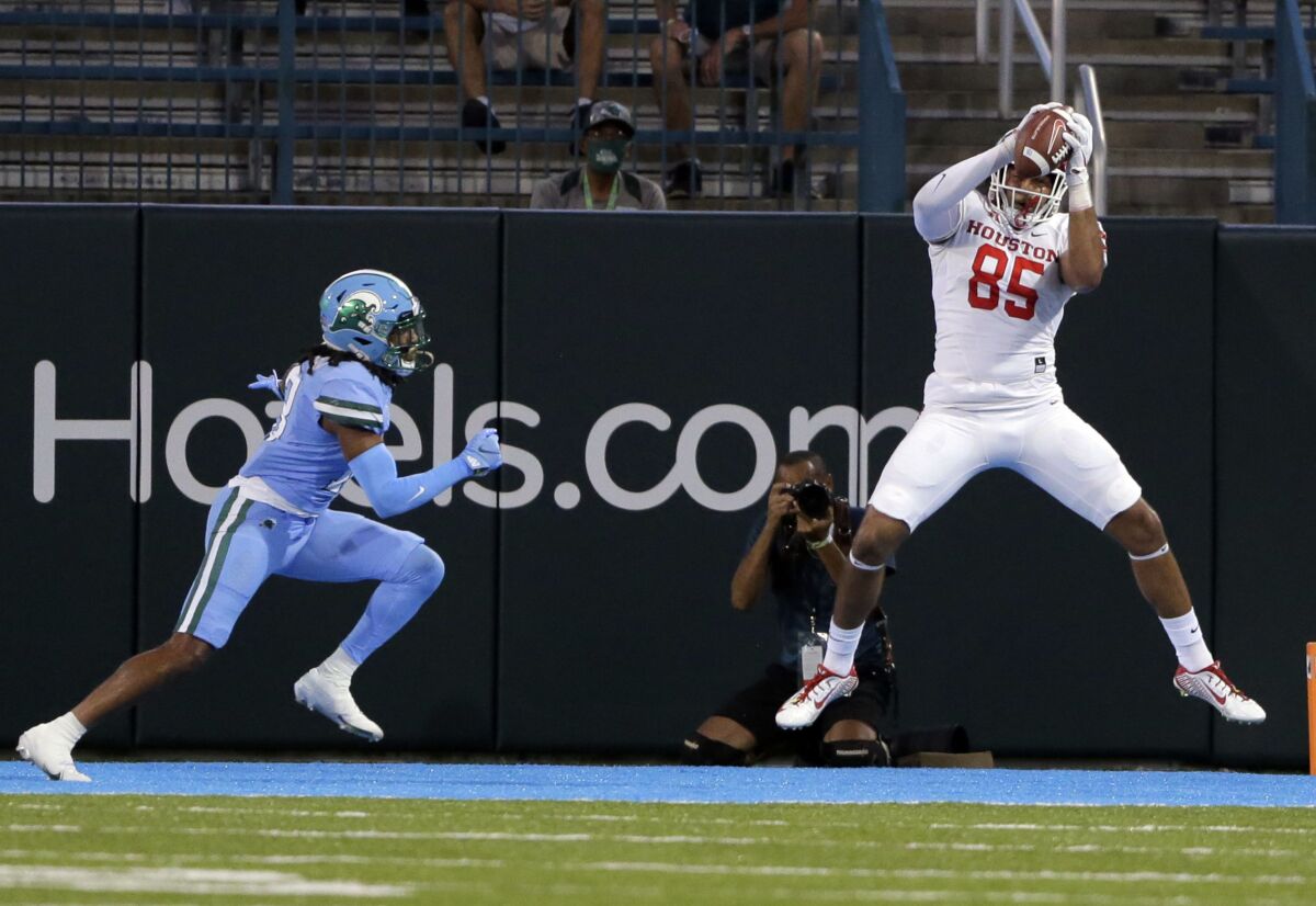 Wide open Houston tight end Christian Trahan (85) catches the ball in the end zone for a touchdown before Tulane defensive back Ajani Kerr (21) can make a play on the ball during an NCAA college football game in New Orleans, Thursday, Oct. 7, 2021. (A.J. Sisco/The Advocate via AP)
