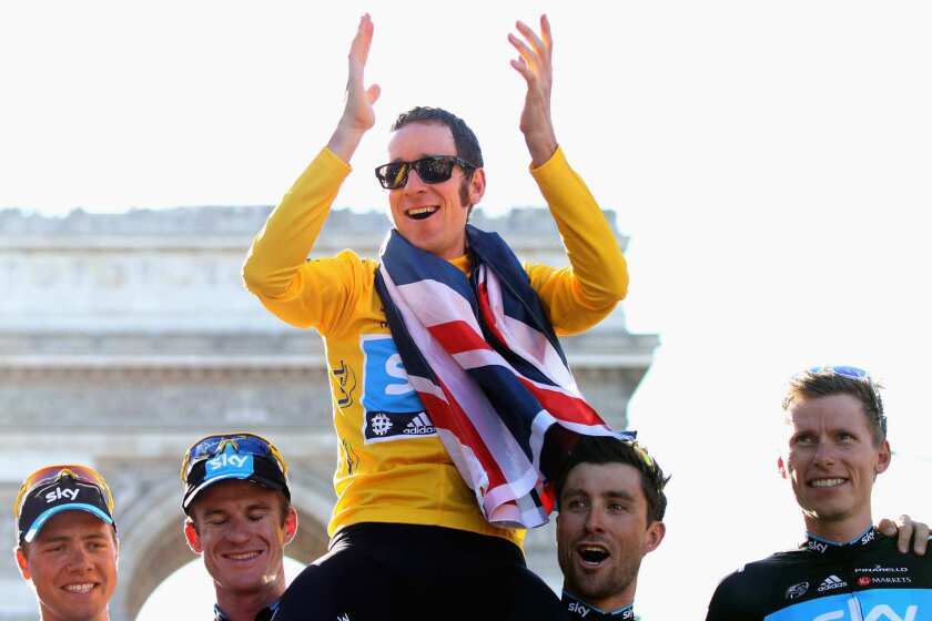 Bradley Wiggins of Great Britain on the Sky Pro Cycling team, top, celebrates with teammates Edvald Boasson Hagen, left, Michael Rogers, Bernhard Eisel and Christian Knees after winning the 2012 Tour de France last Sunday.