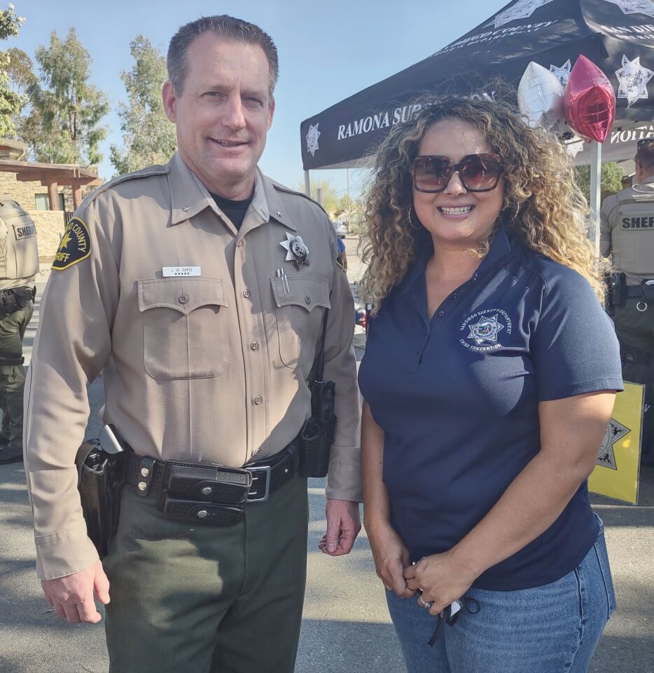 San Diego County Sheriff’s Commander Justin White helps educate the community with Ramona Sheriff’s Crime Prevention Specialist Minnie Estrada.