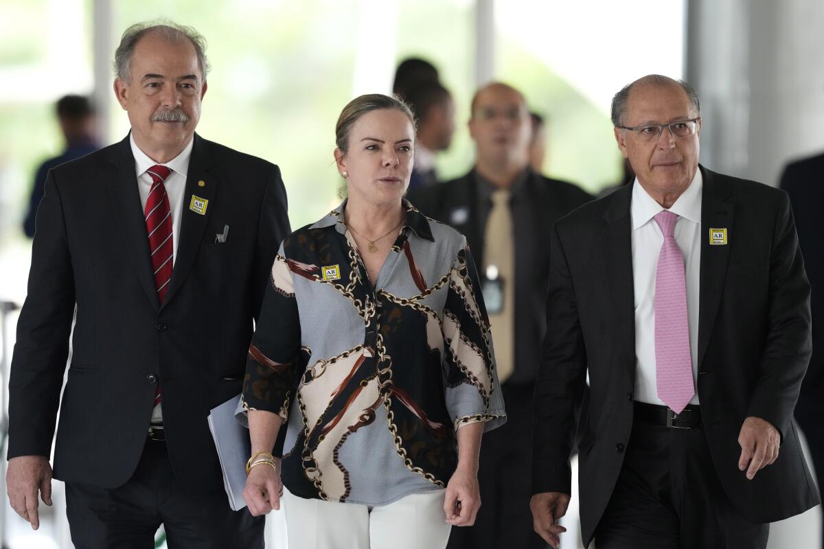 Economist Aloizio Mercadante, from left, Workers' Party President Gleisi Hoffmann and Brazil's Vice President-elect Geraldo Alckmin, arrive for a press conference after meeting with Ciro Nogueira, outgoing President Jair Bolsonaro's chief of staff, at the Planalto Presidential Palace, in Brasilia, Brazil, Thursday, Nov. 3, 2022. President-elect Luiz Inacio Lula da Silva’s team arrived in Brazil’s capital Thursday to begin the process of transferring power. (AP Photo/Eraldo Peres)