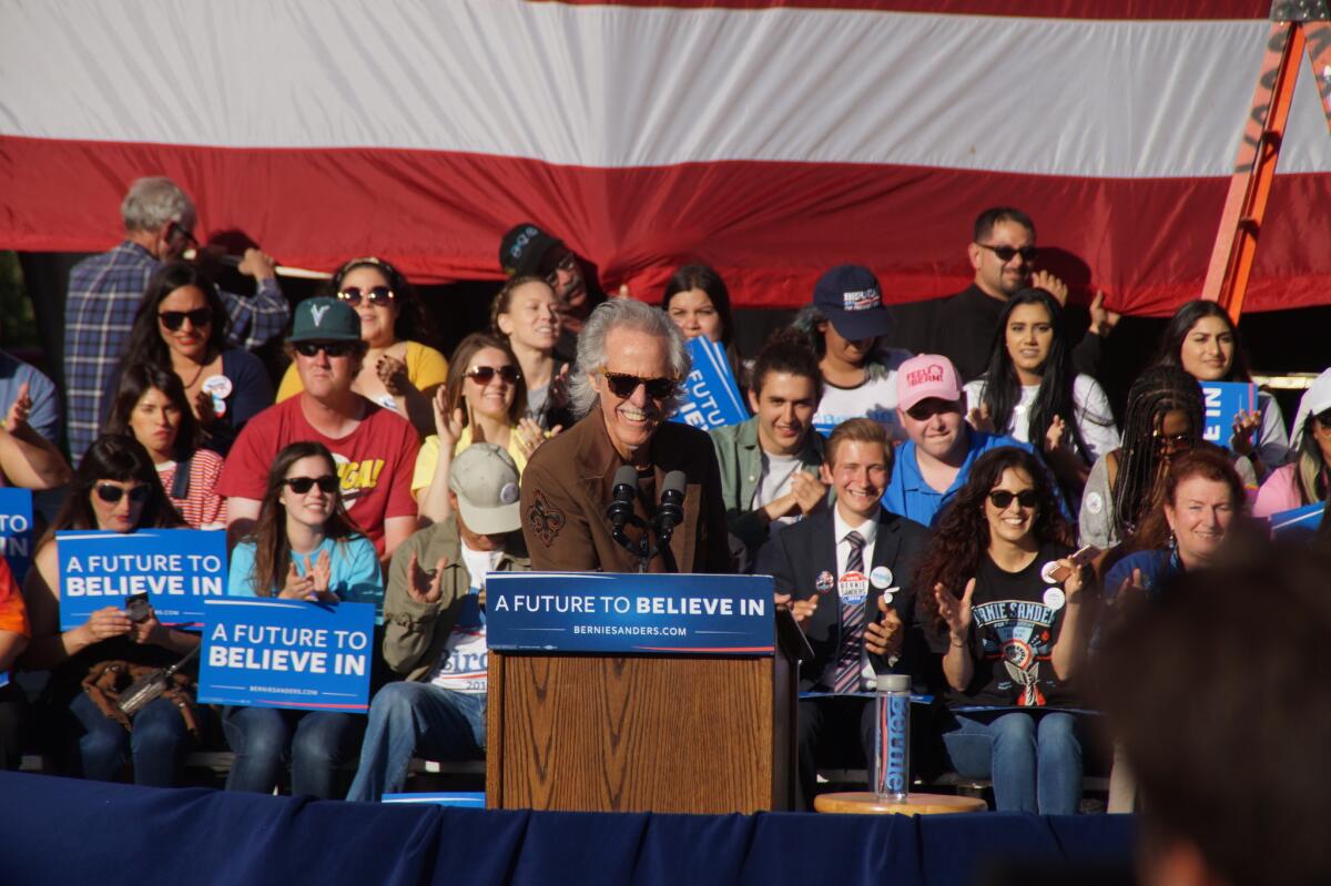 John Densmore, former drummer for the Doors, speaks at Sunday's Bernie Sanders rally in Irvine. “I'm not playing drums,” he said. “No, I'm drumming for Bernie.”