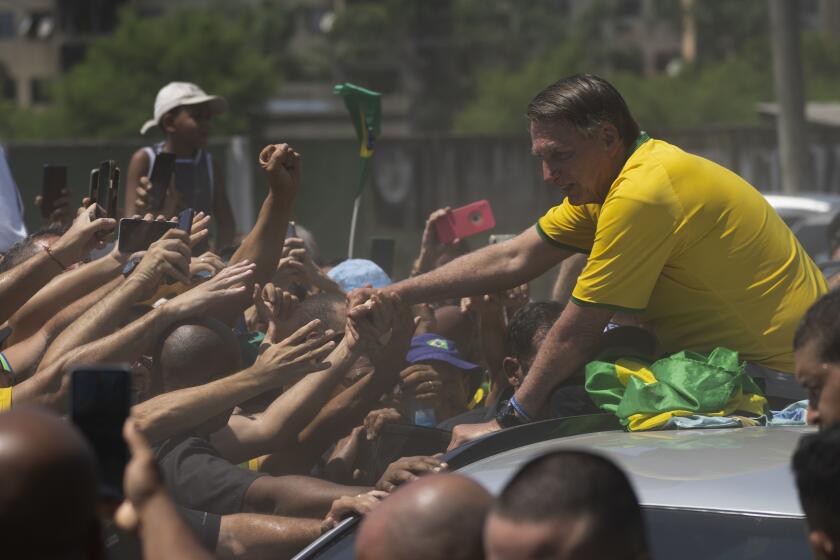 Former Brazil's President Jair Bolsonaro greets supporters after the launch of a campaign event launching the pre-candidacy of a mayoral candidate, in Rio de Janeiro, Brazil, Saturday, March 16, 2024. (AP Photo/Silvia Izquierdo)