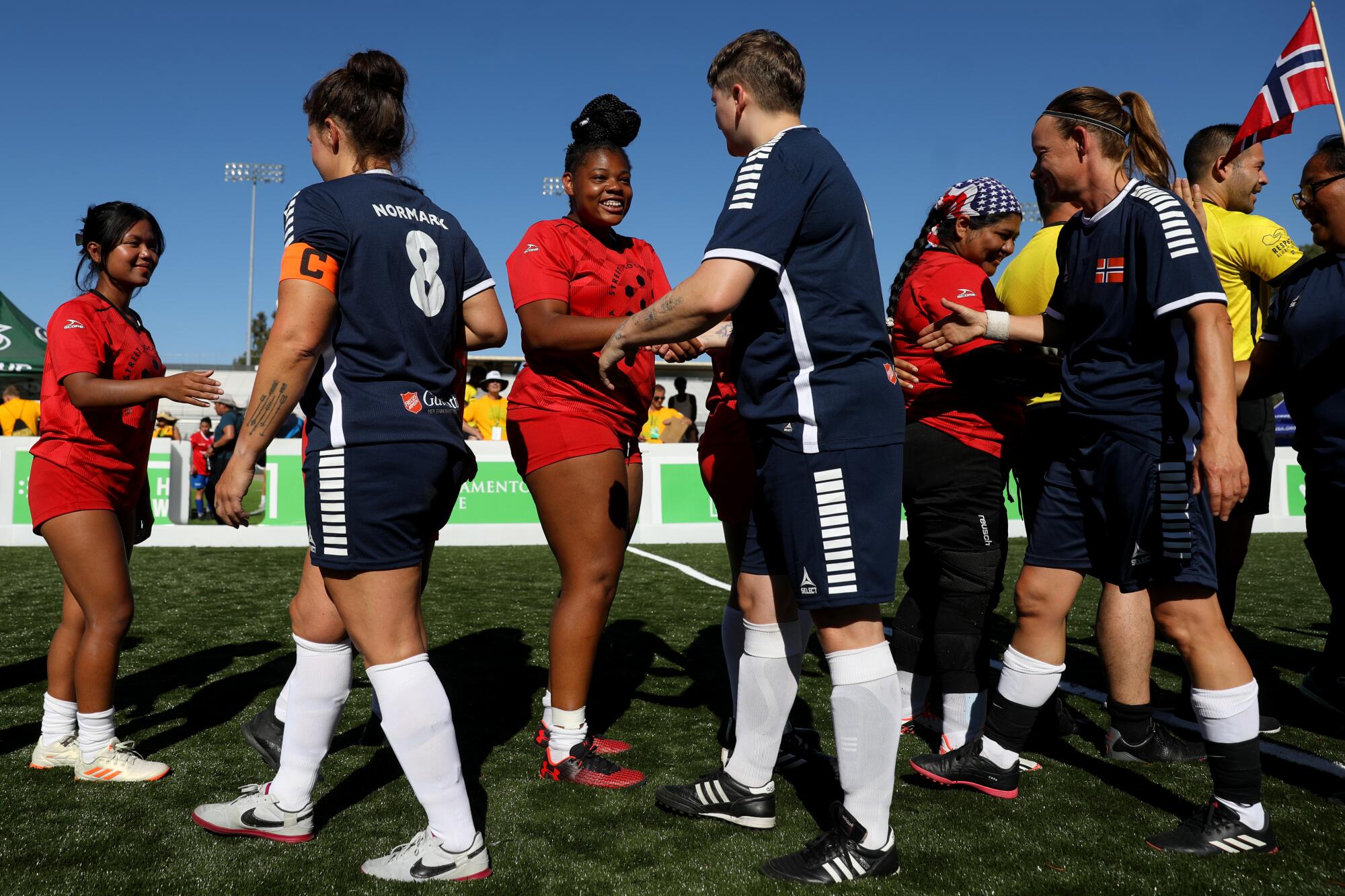 U.S. players shake hands with players representing Norway after a match at the Homeless World Cup on July 11.