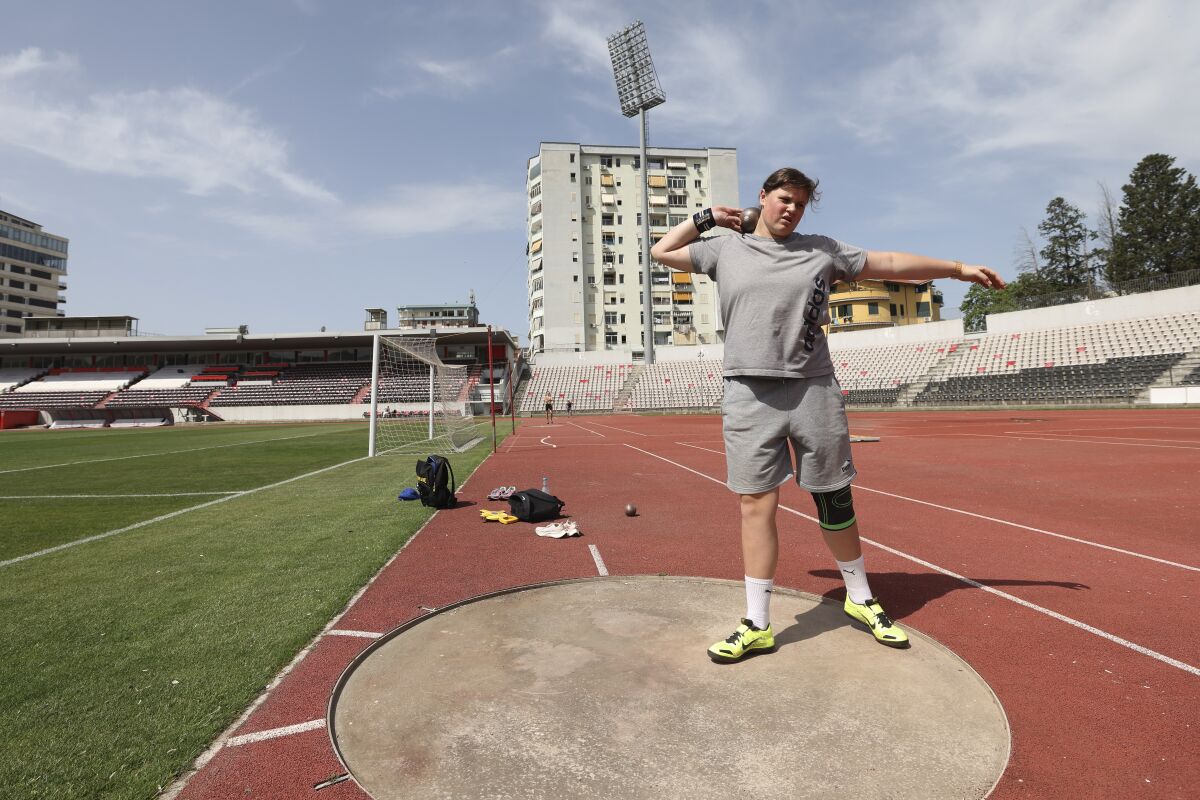 Ukrainian athlete Maria Larina, 17, practices during a training session at Elbasan Arena stadium in Elbasan, about 45 kilometers (30 miles) south of Tirana, Albania, Monday, May 9, 2022. After fleeing from a war zone, a group of young Ukrainian track and field athletes have made their way to safety in Albania. Their minds are still between the two countries. (AP Photo/Franc Zhurda)