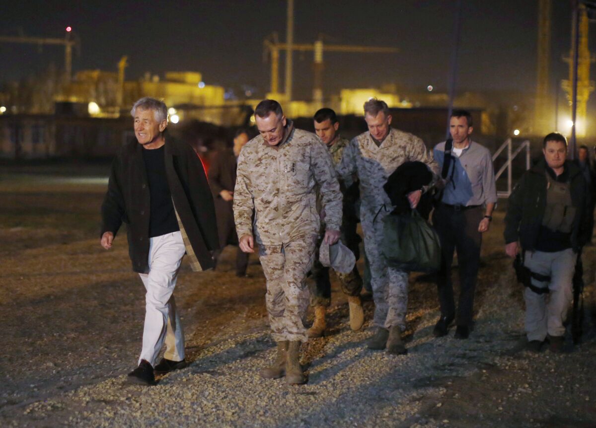 Defense Secretary Chuck Hagel walks with Marine Gen. Joseph Dunford, commander of U.S.-led forces in Afghanistan, after arriving near Camp Eggers in Kabul.