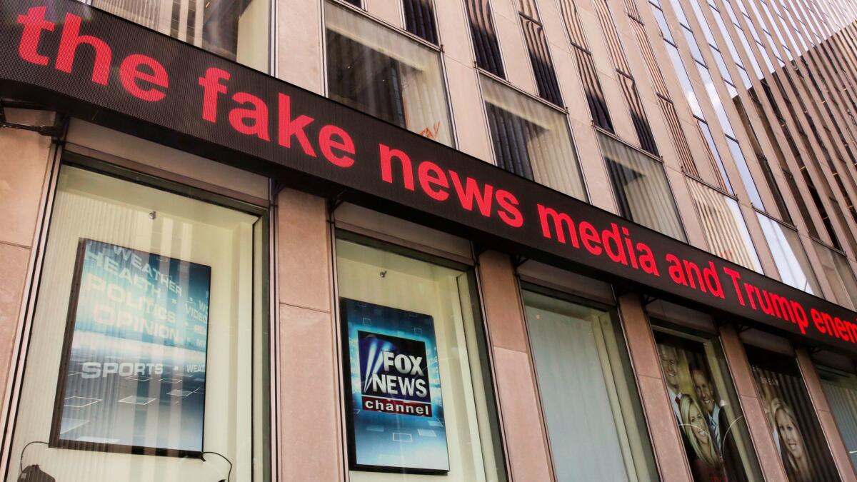 News headlines scroll above the Fox News studios in New York. Fox news filed a motion to dismiss a lawsuit filed by a former contributor.