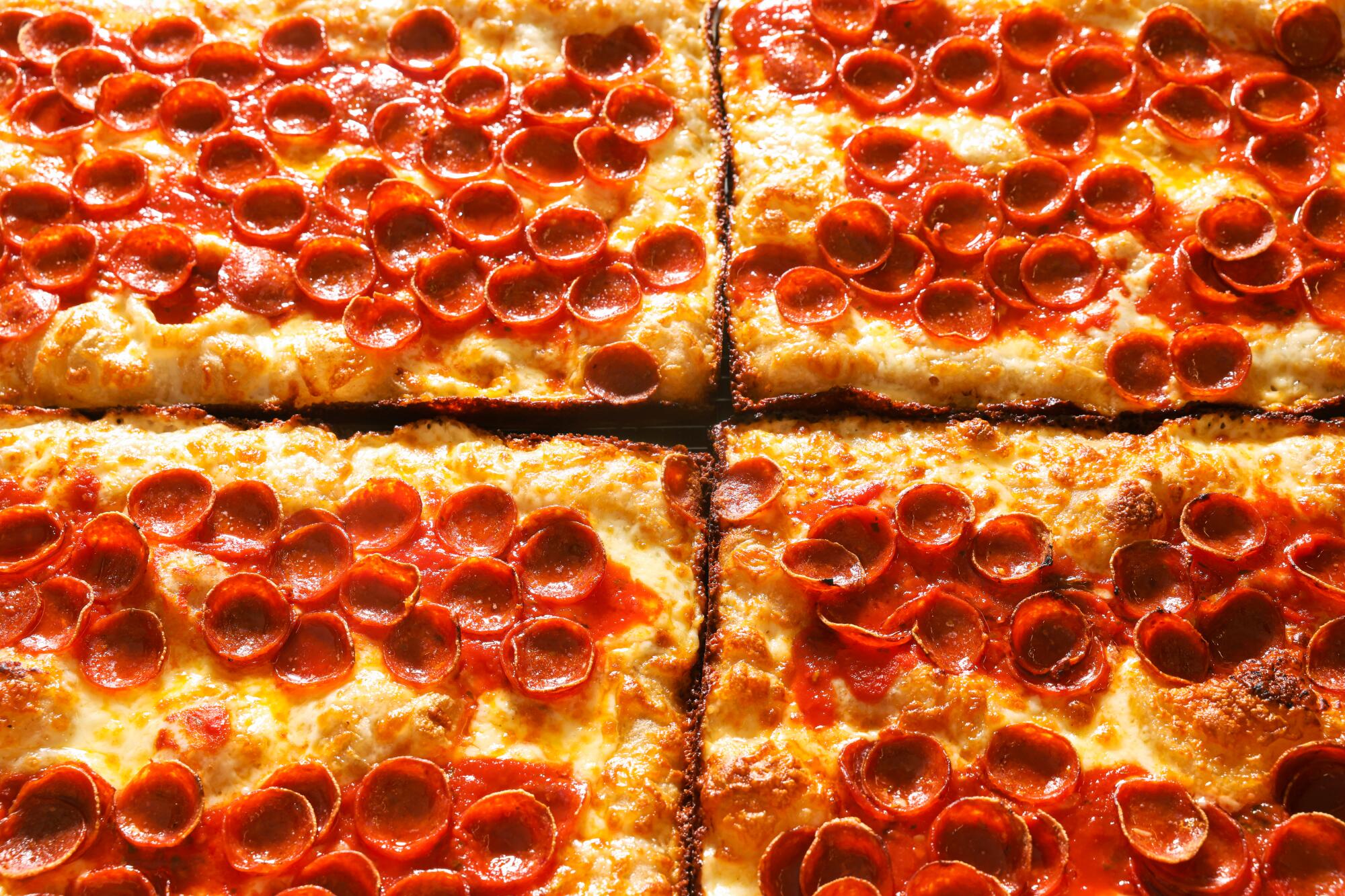 Freshly baked rectangular pepperoni pizzas at Quarters Sheets Pizza Club.