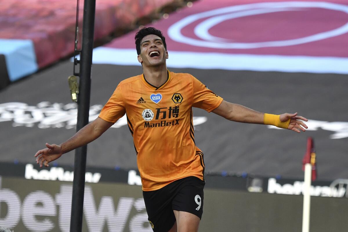FILE - In this Saturday, June 20, 2020 file photo, Wolverhampton Wanderers' Raul Jimenez celebrates after scoring his side's first goal during the English Premier League soccer match between West Ham and Wolverhampton at London stadium in London, England. Jimenez has completed his recovery from a fractured skull and is ready to start the new Premier League season with Wolverhampton. The Mexican forward played in a pre-season friendly against third-division Crewe. Wolverhampton wrote on its Twitter account that “eight months of hard work and rehabilitation have led to this moment.” Jimenez had surgery in late November after a clash of heads with Arsenal defender David Luiz during a Premier League game. (Ben Stansall/Pool via AP, File)