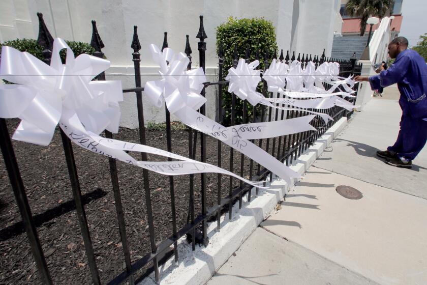 Nine ribbons in honor of the victims killed in last year's shooting at Emanuel AME Church blow in the breeze in front of the church in Charleston, S.C.