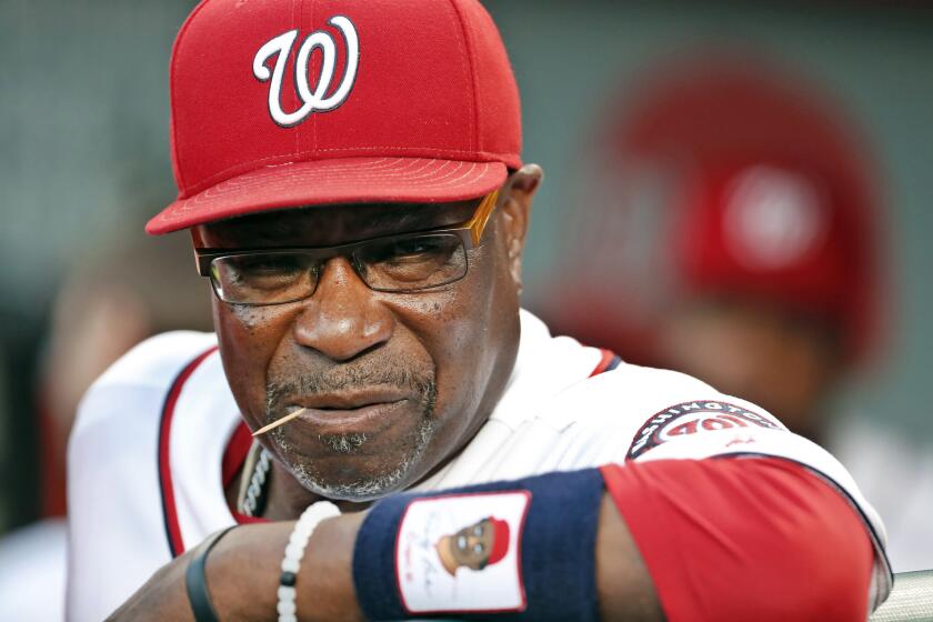 In this Sept. 13, 2016, file photo, Washington Nationals manager Dusty Baker pauses in the dugout before a baseball game against the New York Mets at Nationals Park in Washington.