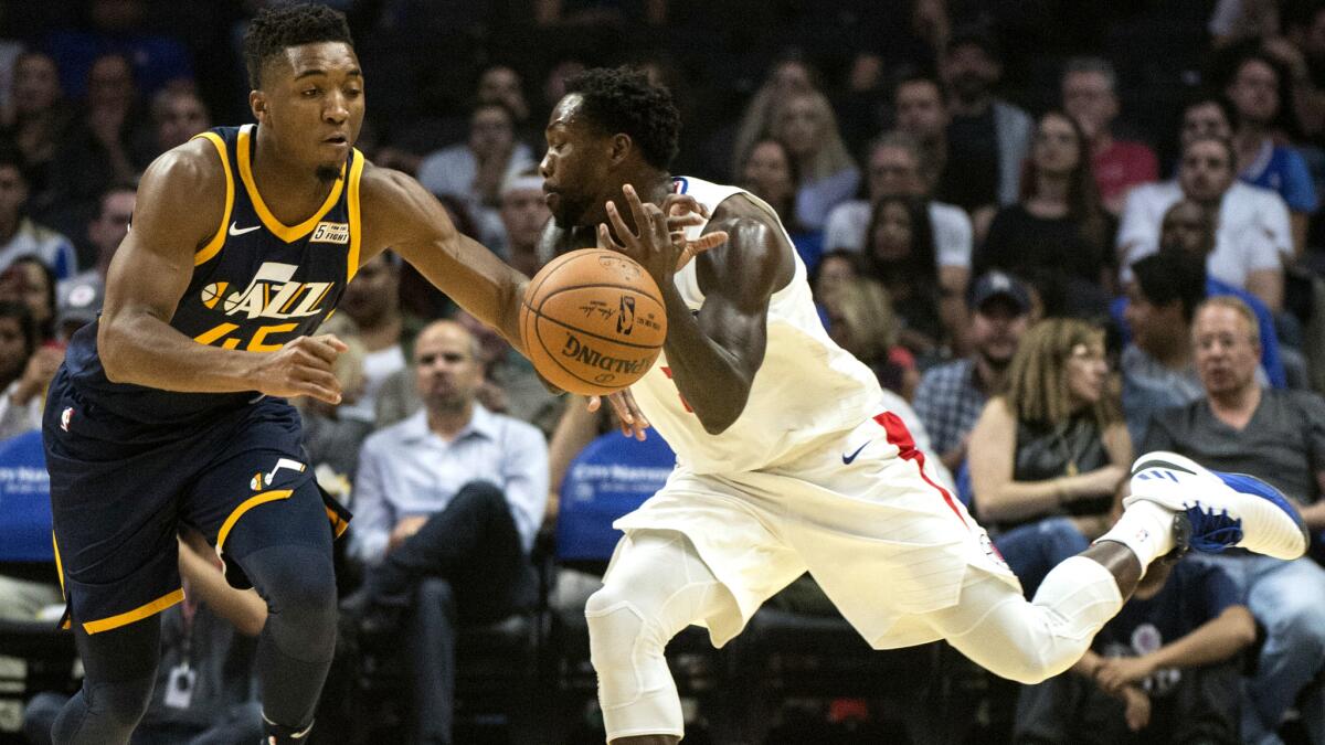 Jazz guard Donovan Mitchell steals the ball from Clippers guard Patrick Beverley during the first half Oct. 25.