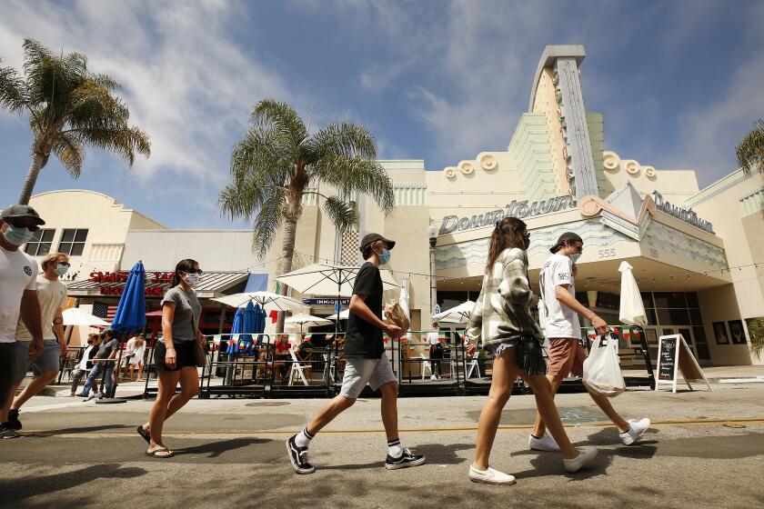 LOS ANGELES, CA - AUGUST 11: Pedestrians are required to wear a mask and practice social distancing when visiting Main Street in downtown Ventura which has been closed to vehicle traffic to allow restaurants and businesses to accommodate for outdoor dining and shopping in the era of the Covid-19 Coronavirus pandemic on August 11, 2020. Los Angeles on Tuesday, Aug. 11, 2020 in Los Angeles, CA. (Al Seib / Los Angeles Times)