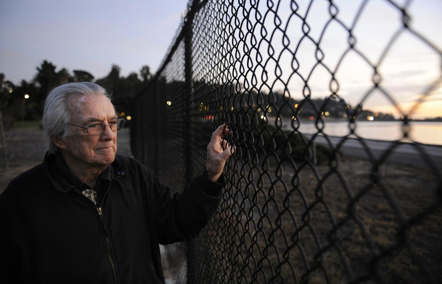 Silver Lake resident Dion Neutra -- an architect who trained under his father, the famed Richard Neutra -- stands at a fence that he wants taken down so the public has access to the reservoir.