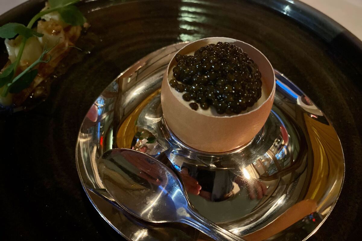 bowl of caviar on a silver platter 