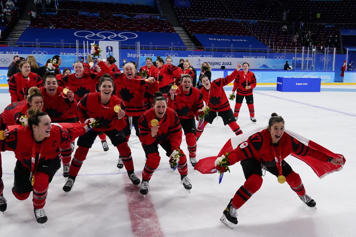 Canada players celebrate with their gold medals after the women's gold medal hockey game at the 2022 Winter Olympics, Thursday, Feb. 17, 2022, in Beijing. (AP Photo/Matt Slocum)