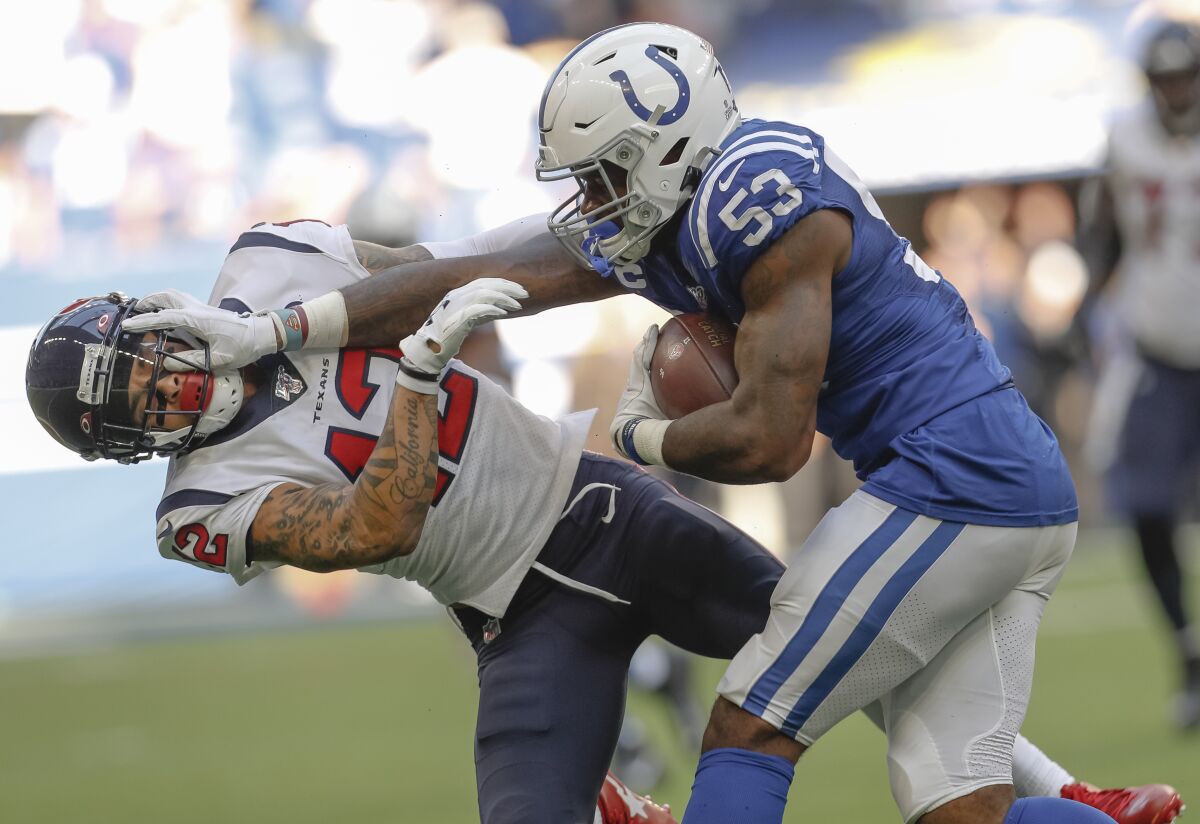 Indianapolis Colts linebacker Darius Leonard stiff arms Houston Texans wide receiver Kenny Stills.