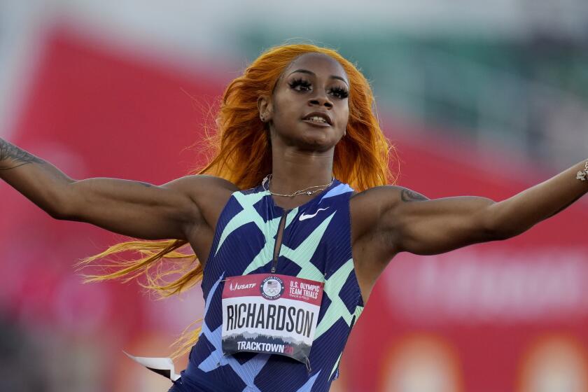 Sha'Carri Richardson celebrates after winning the fourth heat during the women's 100-meter run at the U.S. Olympic Track and Field Trials Friday, June 18, 2021, in Eugene, Ore. (AP Photo/Ashley Landis)