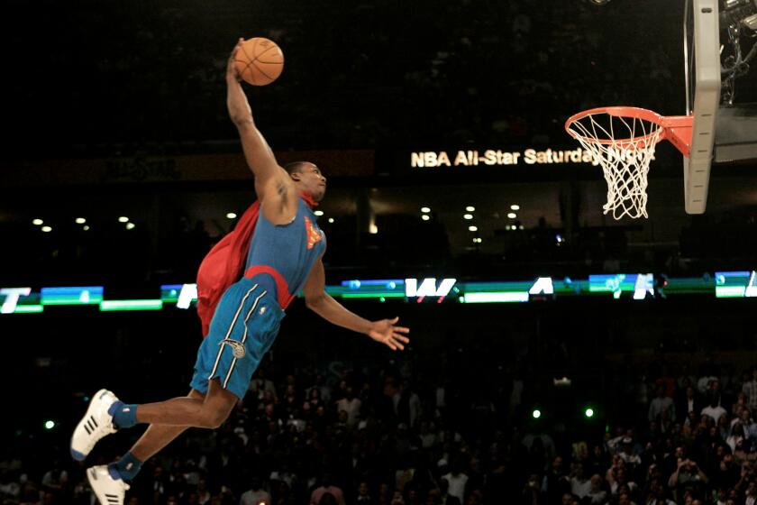 Wearing a Superman costume, Orlando Magic forward Dwight Howard soars toward the basket in the basketball slam dunk contest Saturday, Feb. 16, 2008, at the NBA All Star Weekend in New Orleans. (AP Photo/Eric Gay)