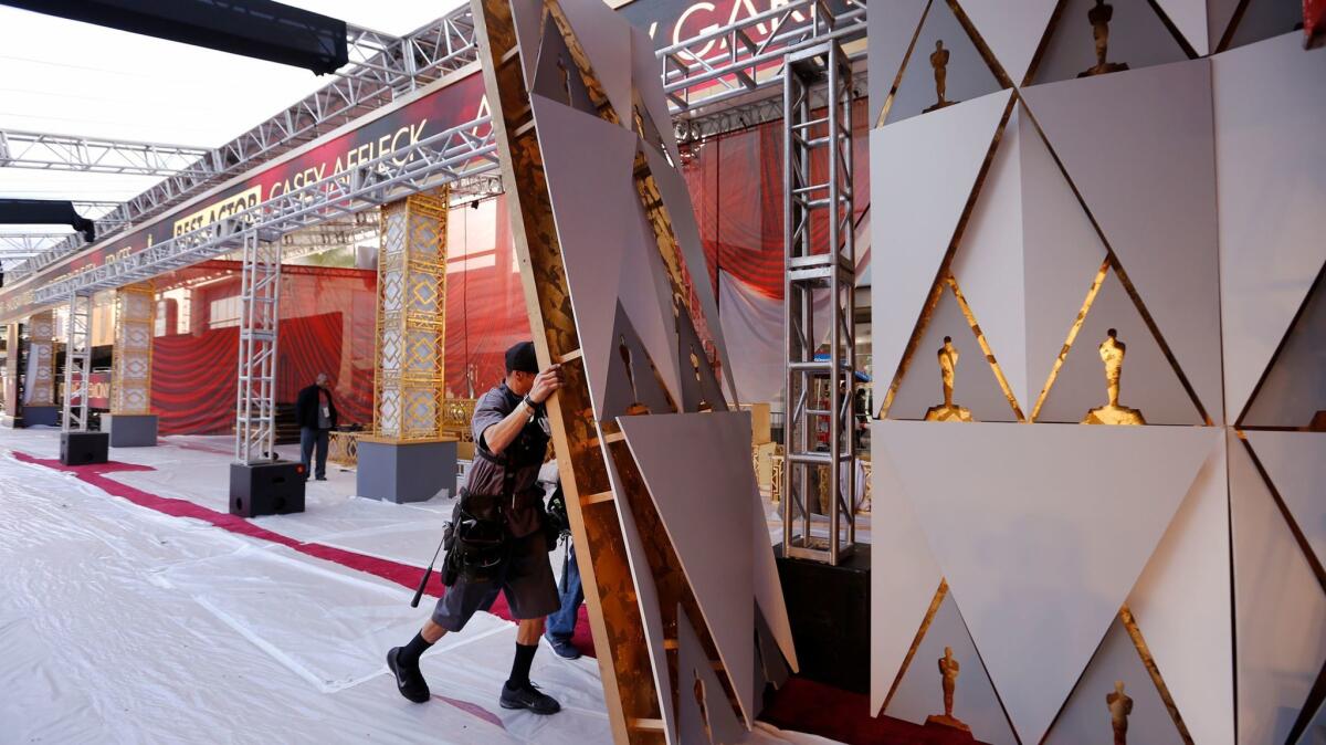 Production rigger Ben Juarez builds a set in front of the Dolby Theatre on Hollywood Blvd. as preparations continue for the 89th Academy Awards ceremony.