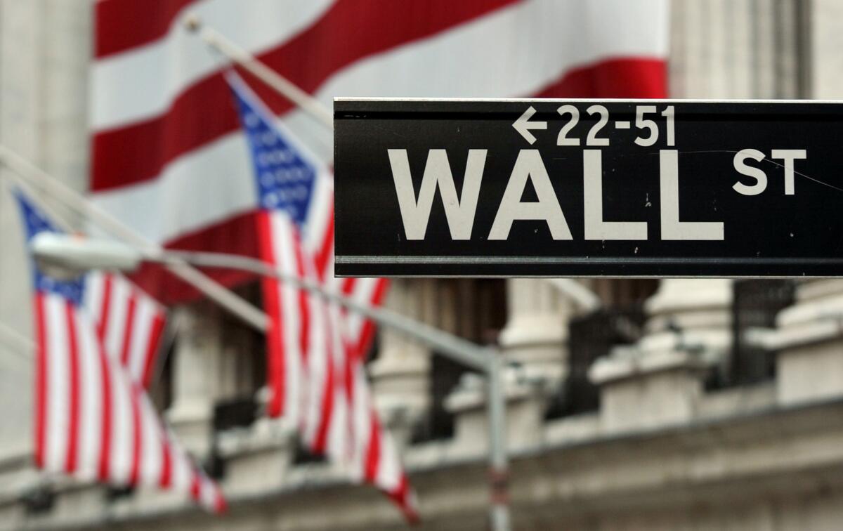 This photo shows the Wall Street sign near the front of the New York Stock Exchange.