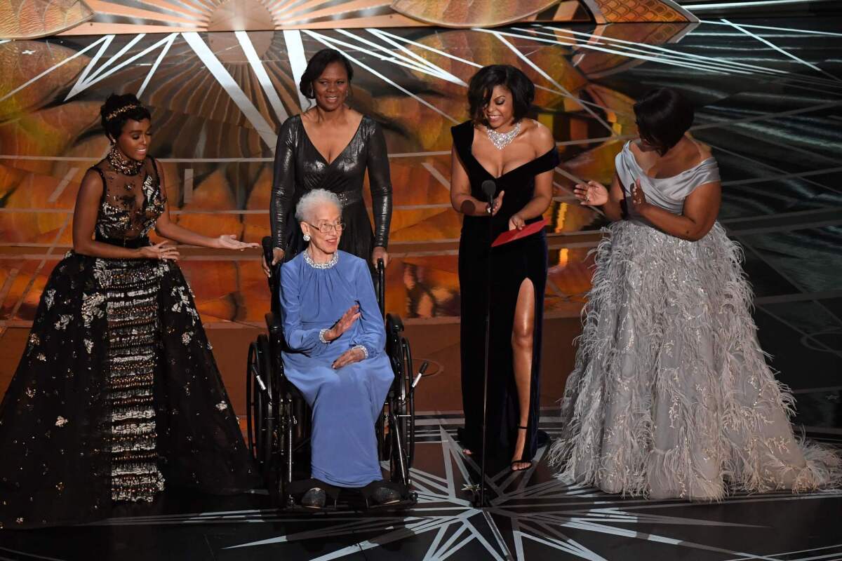 NASA physicist Katherine Johnson, center, is surrounded by, from left, singer-actress Janelle Monae, actress Taraji P. Henson and actress Octavia Spencer as they present on stage the documentary feature award at the 89th Oscars.