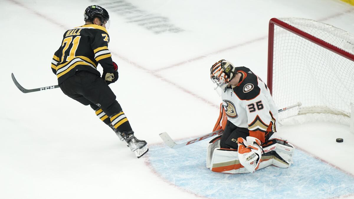 Boston Bruins left wing Taylor Hall scores the winning goal as Ducks goaltender John Gibson is unable to block the shot.