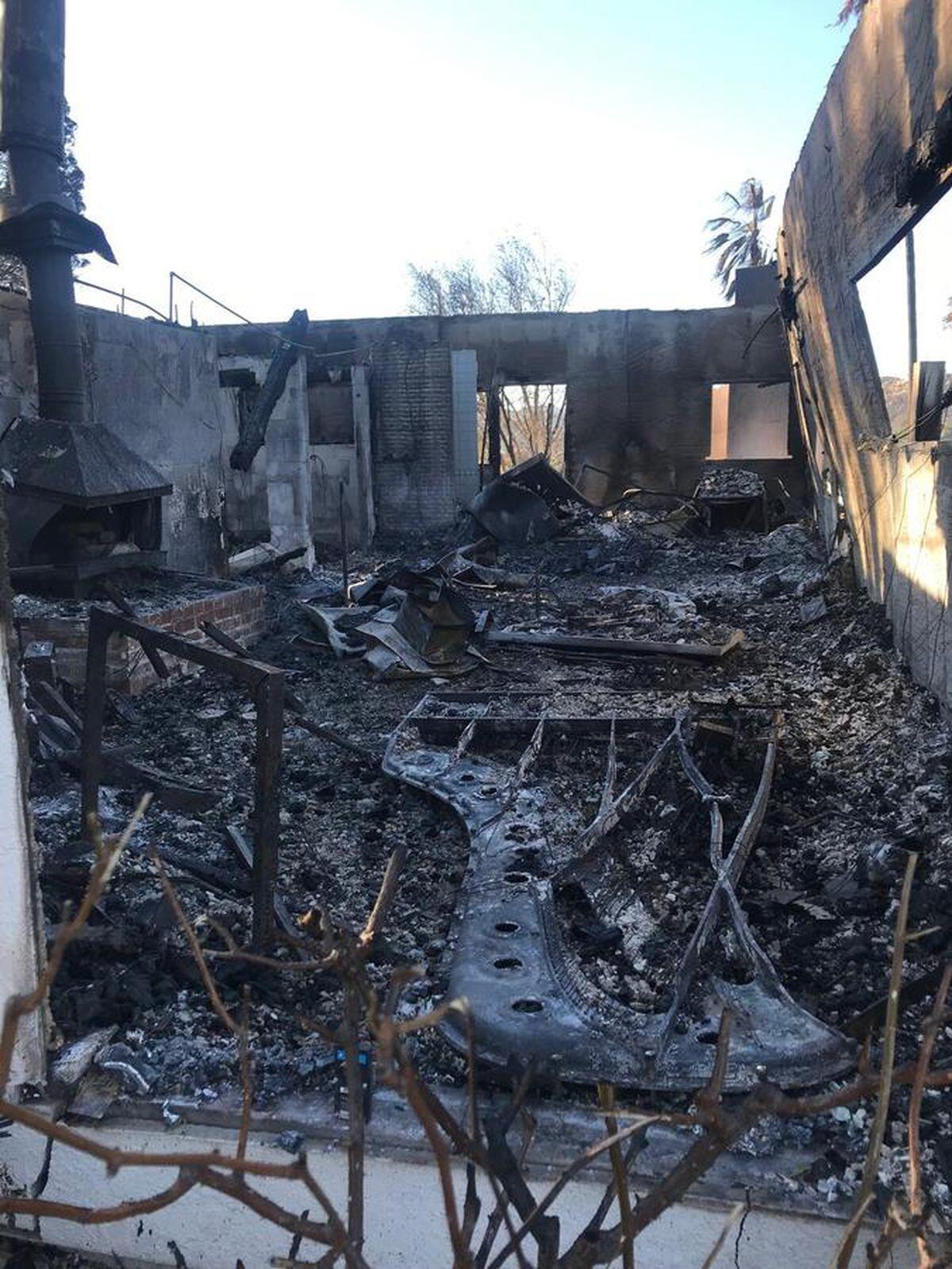 The charred remains of a piano can be seen at what was the Bell Canyon house of musician Mike Garson.