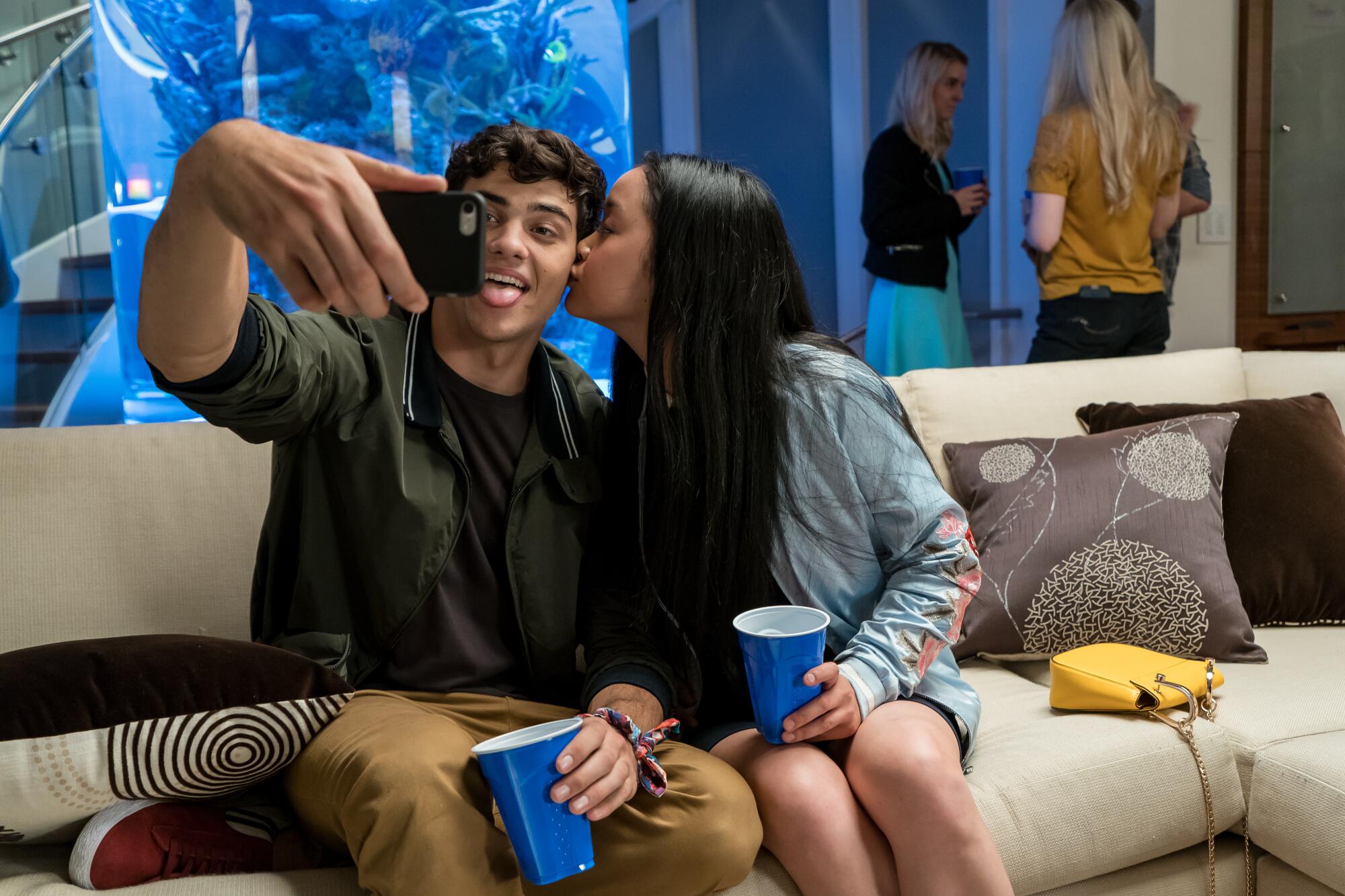 Lana Condor kisses Noah Centineo's cheek in "To All the Boys I've Loved Before."
