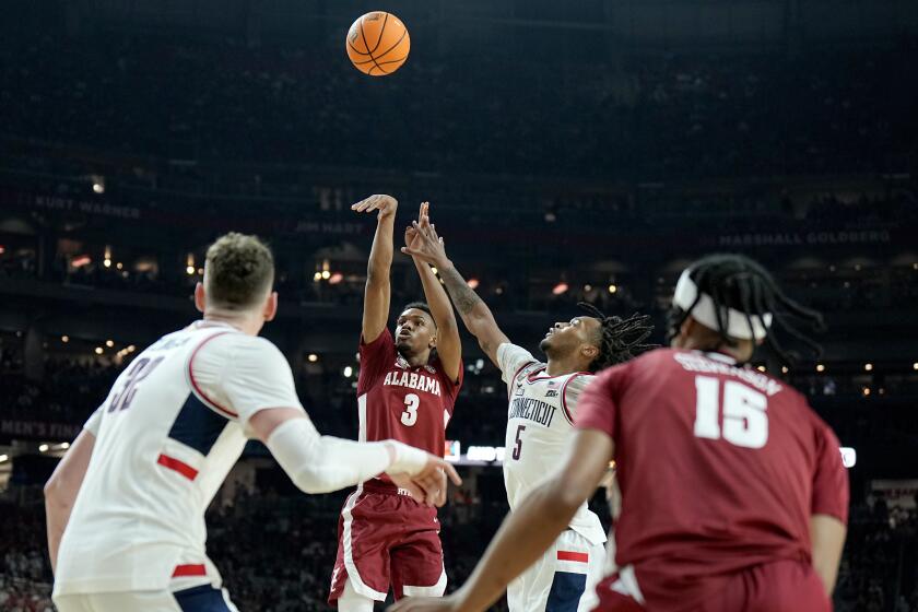 Alabama guard Rylan Griffen (3) shoots over UConn guard Stephon Castle (5) during the second half of the NCAA college basketball game at the Final Four, Saturday, April 6, 2024, in Glendale, Ariz. (AP Photo/Brynn Anderson )