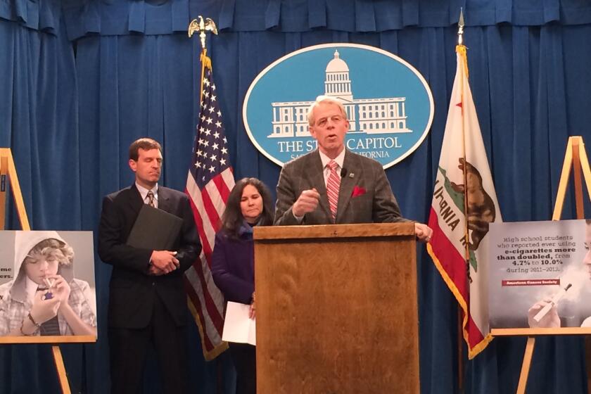 Assemblyman Roger Dickinson (D-Sacramento) is joined by Brad Strong, left, of Children Now and Kori Titus of Breathe California of Sacramento-Emigrant Trails as he announces his new bill to ban most Internet sales of cigarettes, tobacco products and e-cigarettes.