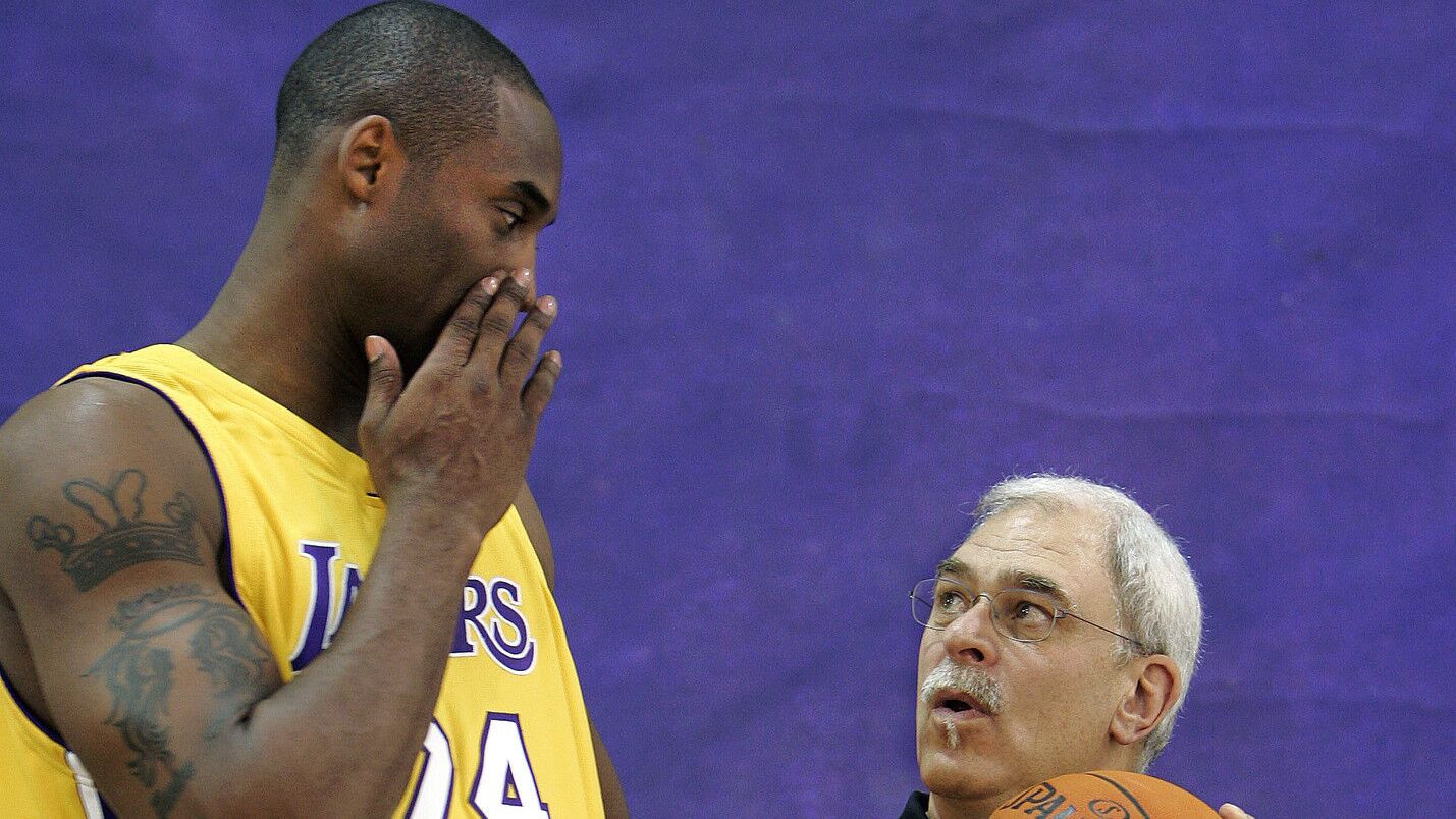 Kobe Bryant, left, whispers to coach Phil Jackson in between being photographed during Lakers' media day on Oct. 2, 2006.
