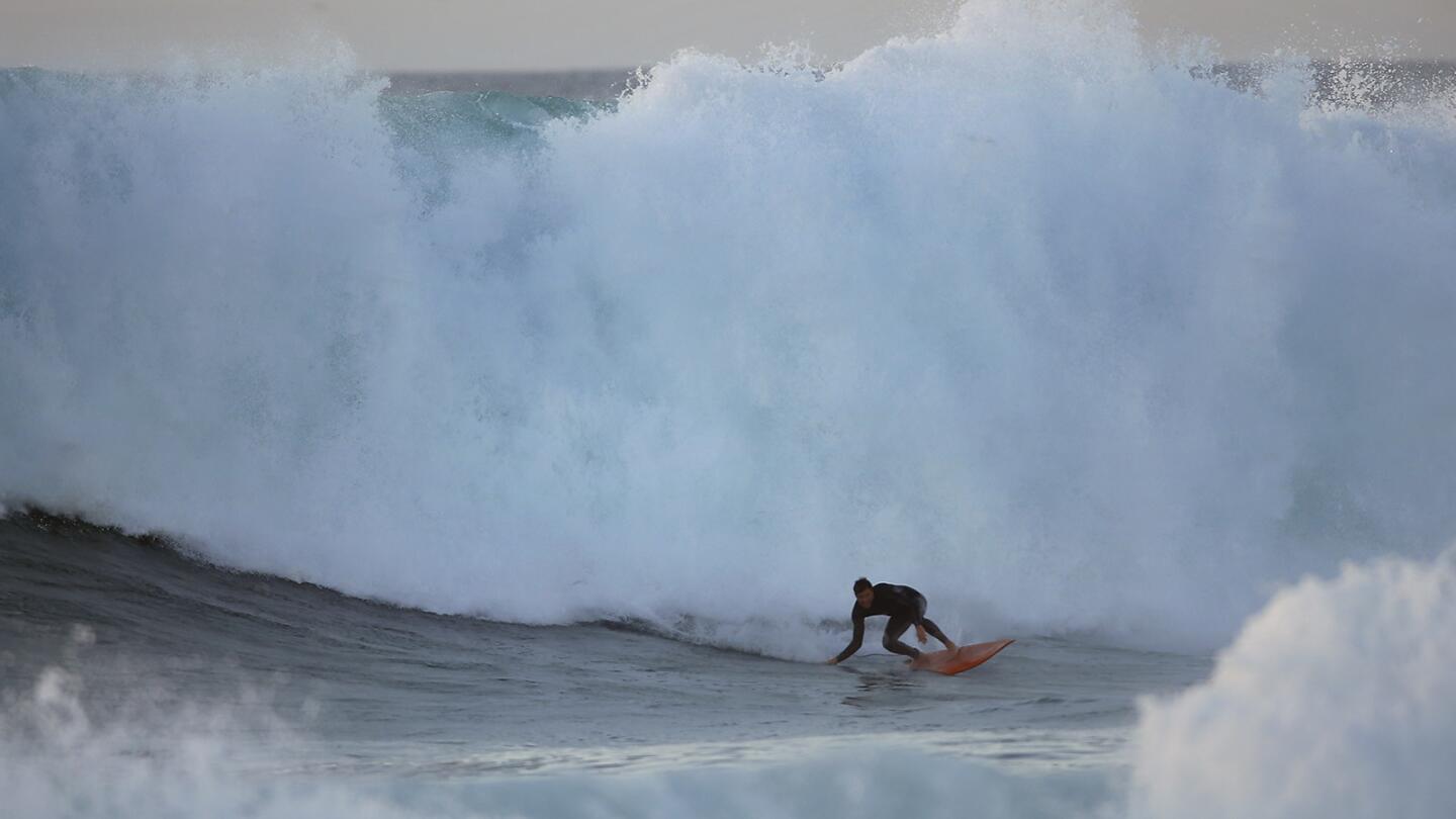 Surfer Jimmy LeBeau rides a wave at sunset in La Jolla as large surf pounded the San Diego coast on Dec. 17, 2018. (Photo by K.C. Alfred/San Diego Union-Tribune)