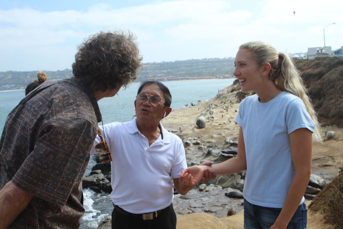 Koch and his daughter Emi (right) ask Pham about his life. Emi is a renown surfer, founder of an international coastal nonprofit, and National Geographic's 2018 Adventurer of the Year.