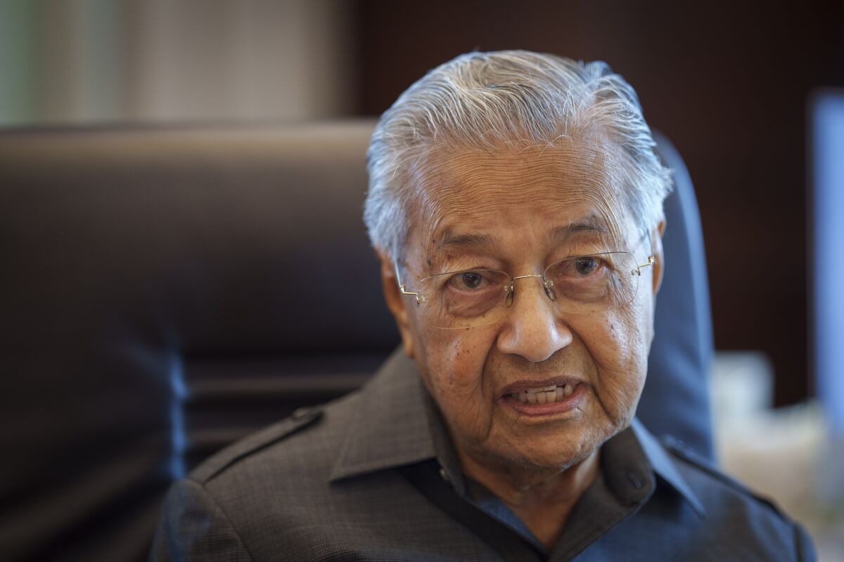 Malaysia's former Prime Minister Mahathir Mohamad speaks during an interview with The Associated Press at his office in Kuala Lumpur, Malaysia, Friday, Aug. 19, 2022. Mahathir expects Malaysia’s graft-tainted ruling party will hold general elections in coming months, and could win big, but the nonagenarian reformer vowed Friday that he would fight "even a losing battle" on principle. (AP Photo/Vincent Thian)