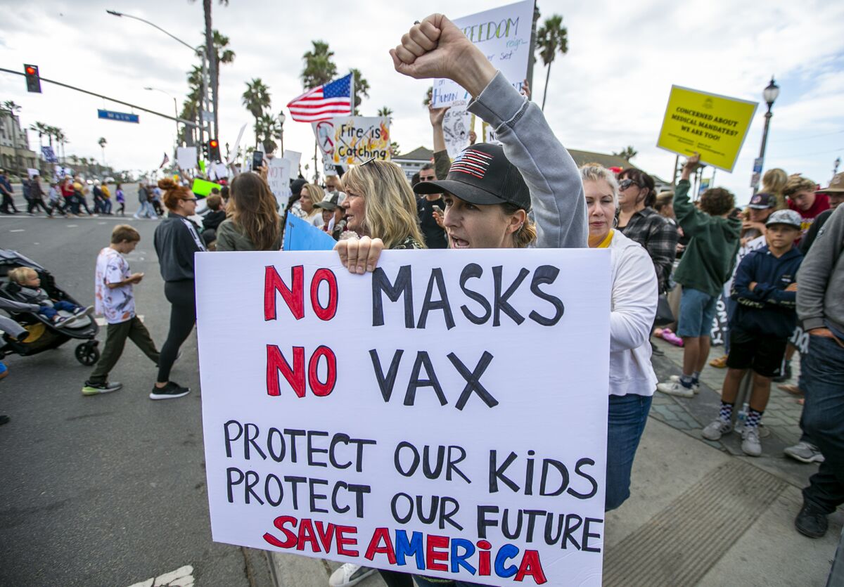 Sarita Brown, from Lakewood, chants during a protest to oppose vaccination mandates at the Huntington Beach Pier on Monday.