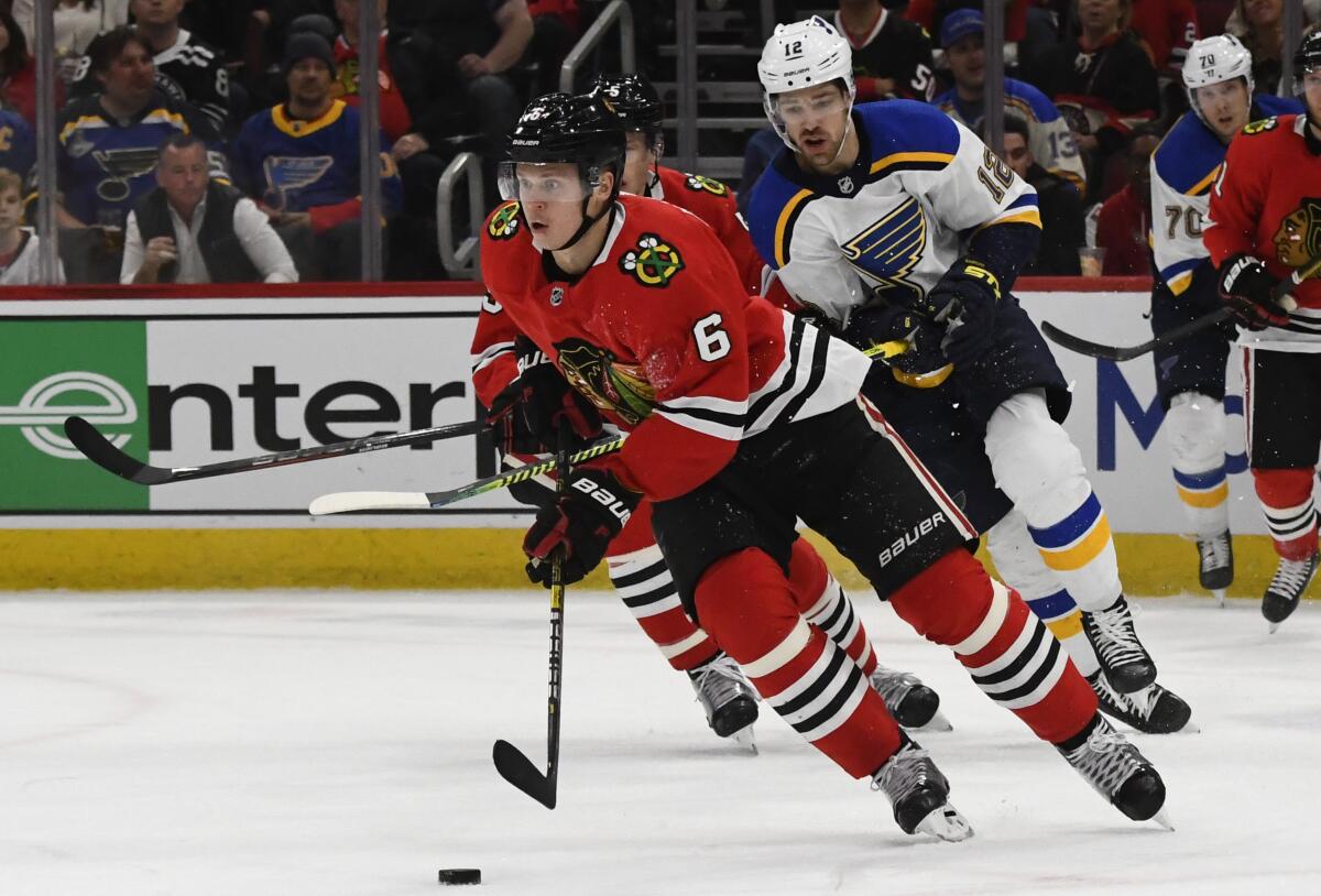 Chicago Blackhawks defenseman Olli Maatta moves the puck away from St. Louis Blues left wing Zach Sanford.