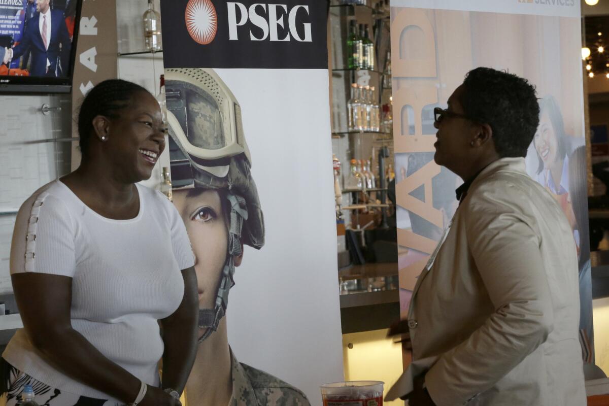 Sophia Lewis, left, with PSEG Long Island, speaks to an attendee at a Citi Field job fair in New York on June 30.