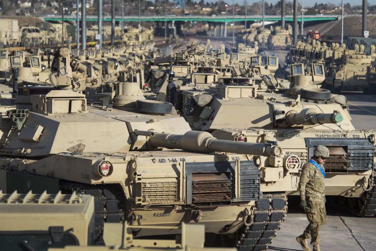 FILE - A soldier walks past a line of M1 Abrams tanks, Nov. 29, 2016, at Fort Carson in Colorado Springs, Colo. U.S. officials say the Pentagon is speeding up its delivery of Abrams tanks to Ukraine, opting to send a refurbished older model that can be ready faster. The aim is to get the 70-ton battle powerhouses to the war zone in eight to 10 months. (Christian Murdock/The Gazette via AP, File)