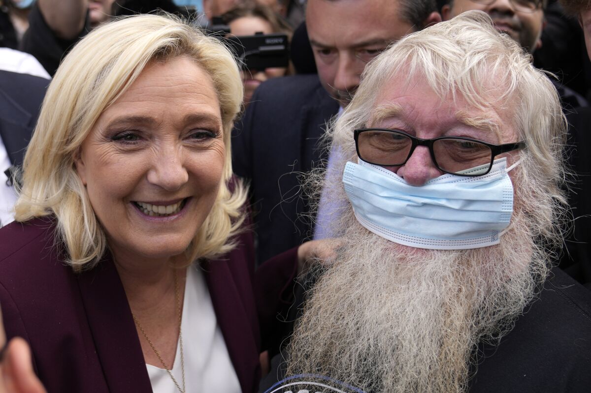 French far-right leader Marine Le Pen poses for a photo after a press conference Tuesday, April 12, 2022 in Vernon, west of Paris. The thought of an extreme-right leader standing at the helm of the European Union would be abhorrent to most in the 27-nation bloc. But if Emmanuel Macron falters in the April 24 French presidential elections, it might be two weeks away. (AP Photo/Francois Mori)
