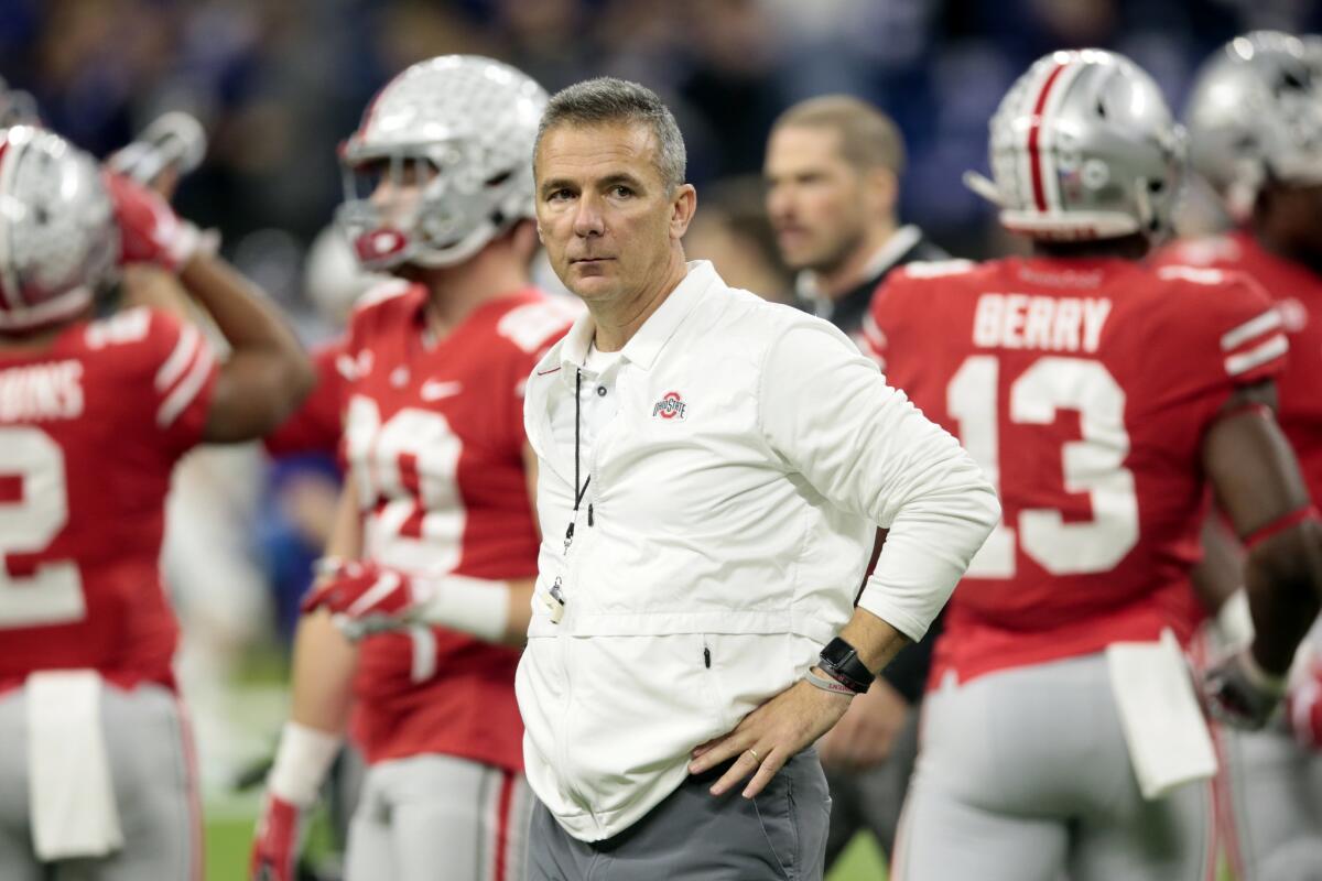 Urban Meyer watches Ohio State players warm up for the Big Ten championship game in December 2018.