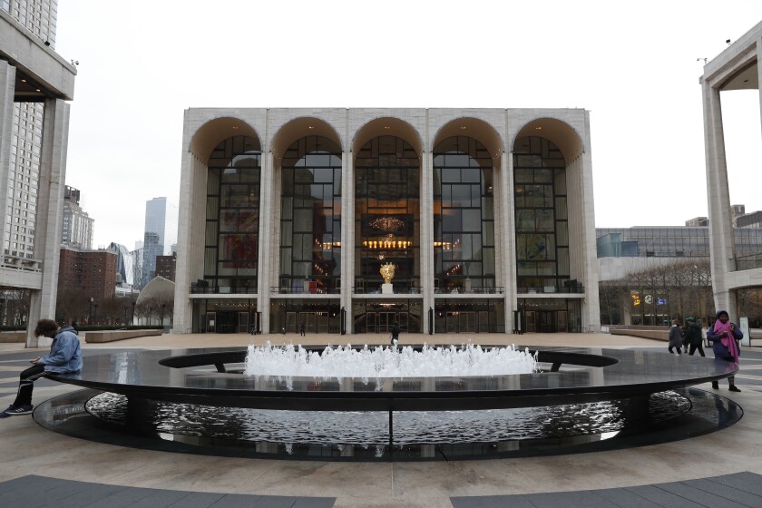 FILE - This March 12, 2020, file photo shows Josie Robertson Plaza in front of The Metropolitan Opera house, background center, at Lincoln Center in New York. On Tuesday, May 11, 2021, the Metropolitan Opera reached a tentative agreement on a four-year contract with the American Guild of Musical Artists, one of three major labor deals needed for the New York company to resume performances in September. (AP Photo/Kathy Willens, File)