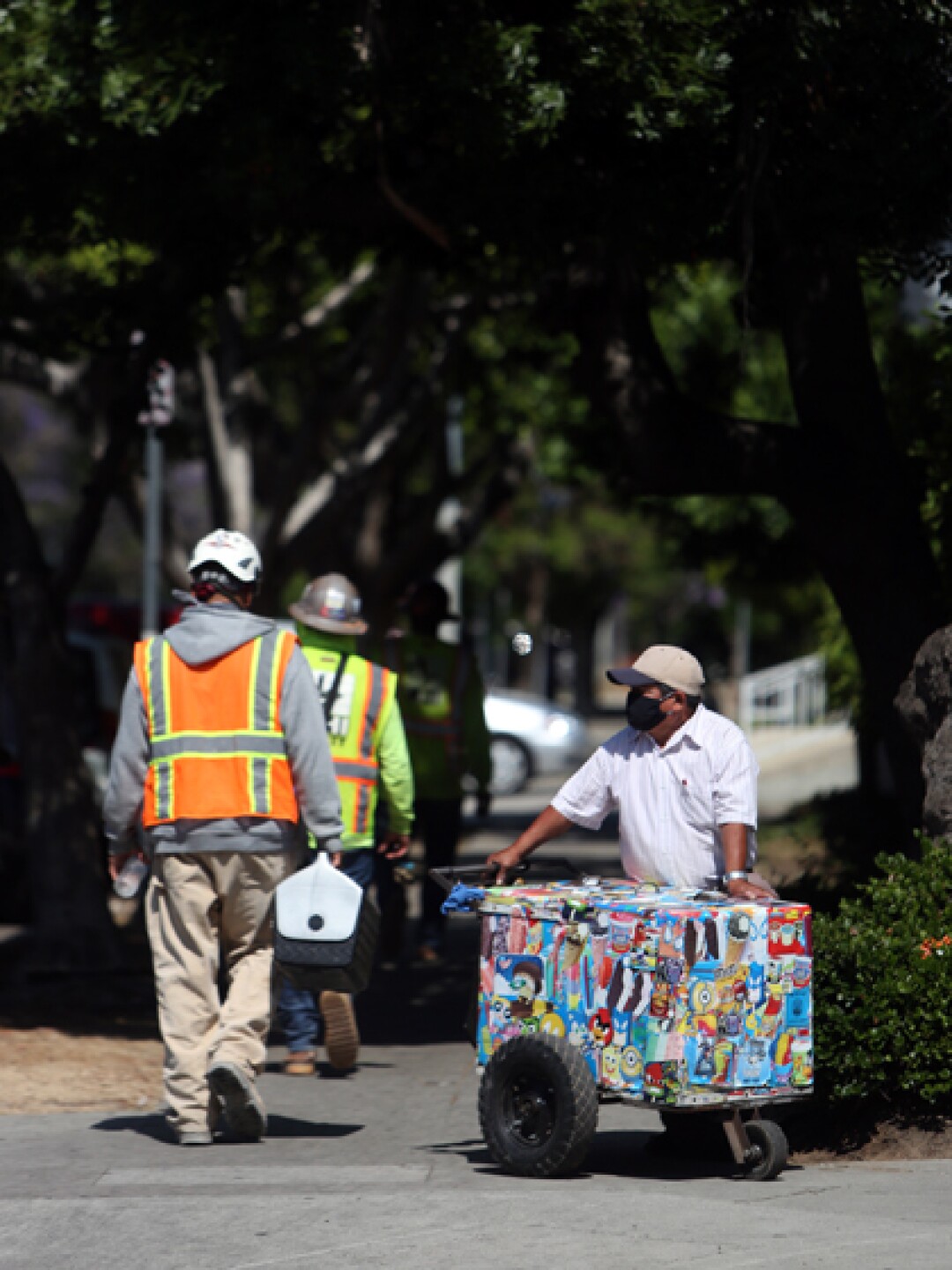 Mauro Rios Parra moves his cart near a construction site where workers sometimes buy paletas.