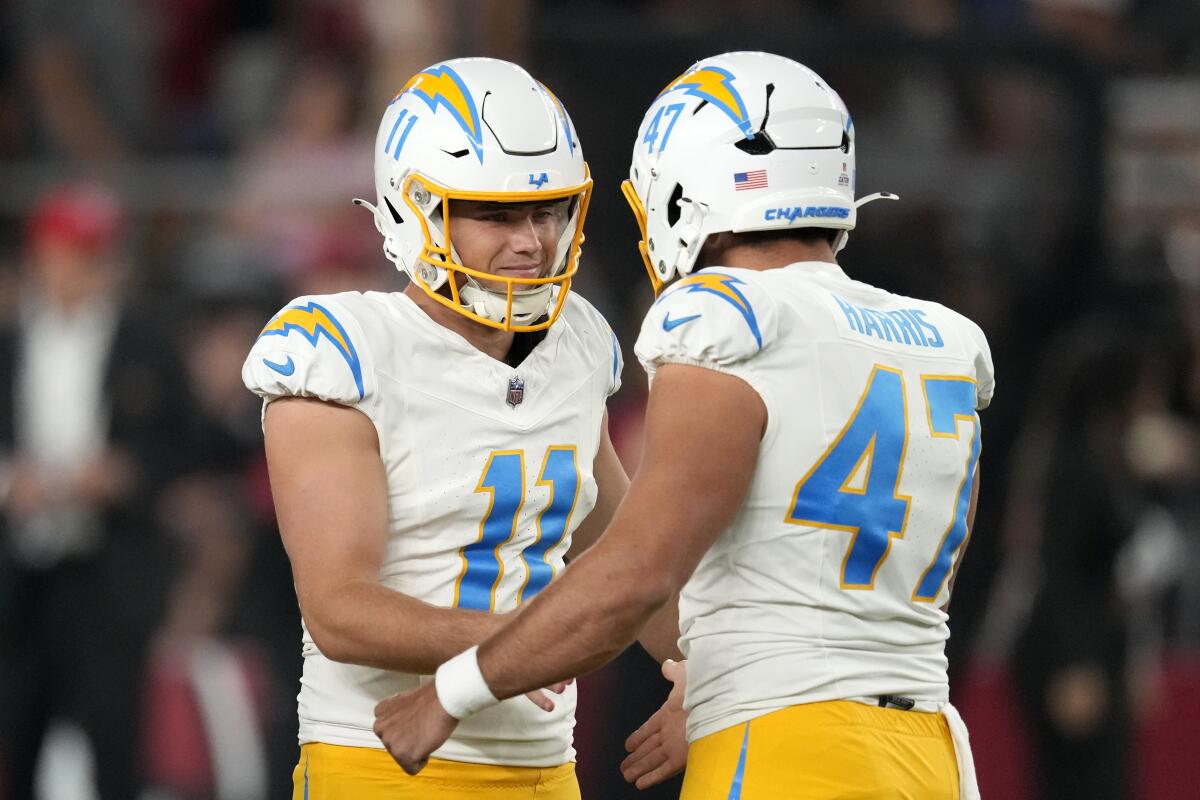 Chargers kicker Cameron Dicker (11) celebrates with teammate Josh Harris.