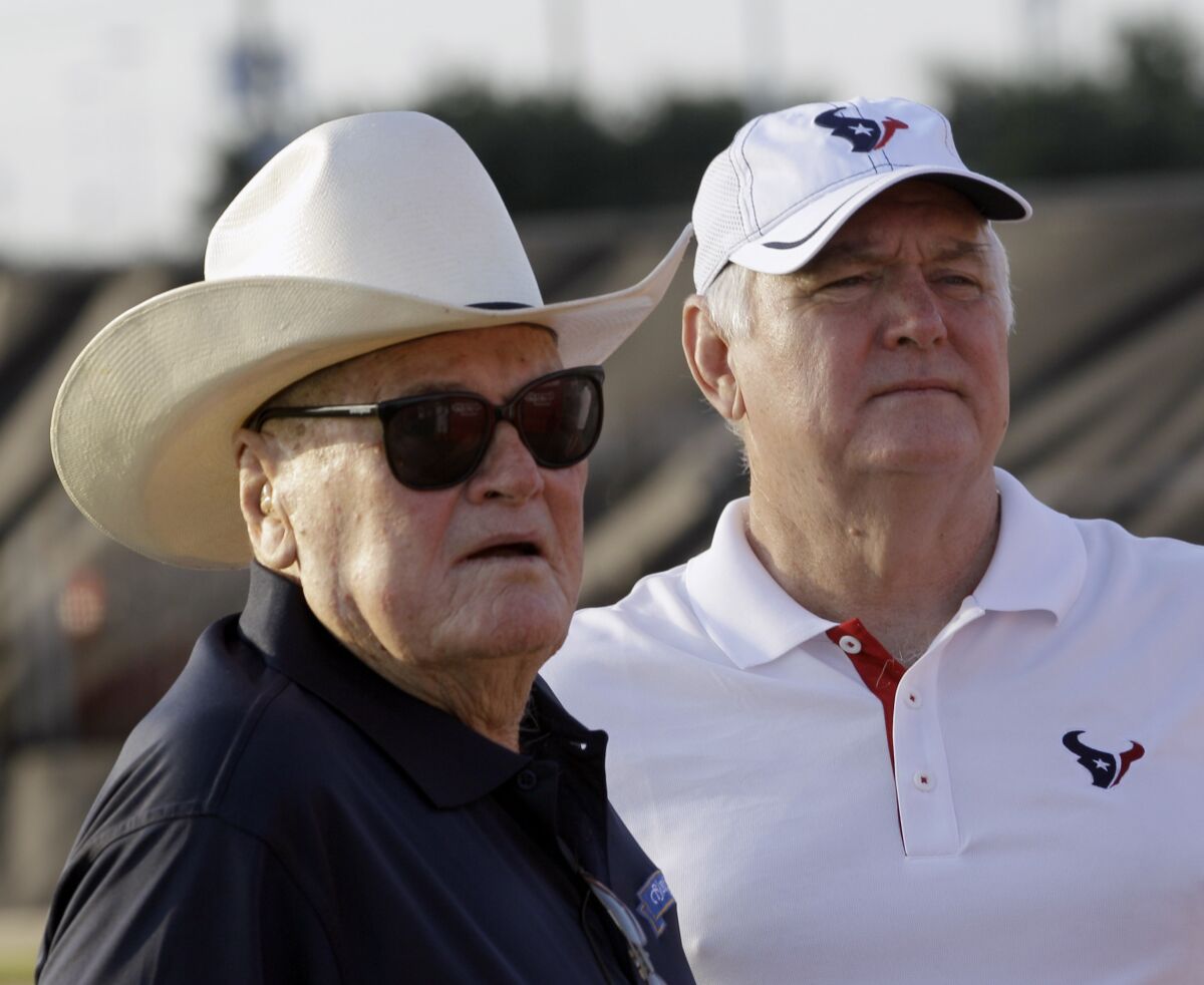 FILE - Houston Texans defensive coordinator Wade Phillips, right, and his father, Bum Phillips look on before an NFL football training camp practice Aug. 3, 2011, in Houston. Bum lost two AFC championship games as head coach of the Houston Oilers. His son Wade coached 42 years in the NFL as both a head coach and longtime defensive coordinator, reaching three Super Bowls and winning only one. (AP Photo/David J. Phillip, File)