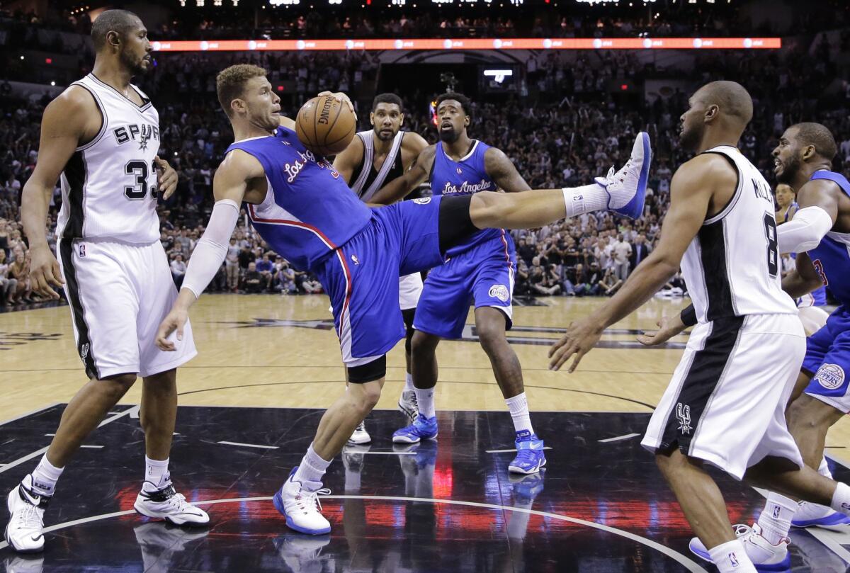 Clippers power forward Blake Griffin tries to maintain his balance as he pulls down a rebound against the Spurs during the second half of Game 6.
