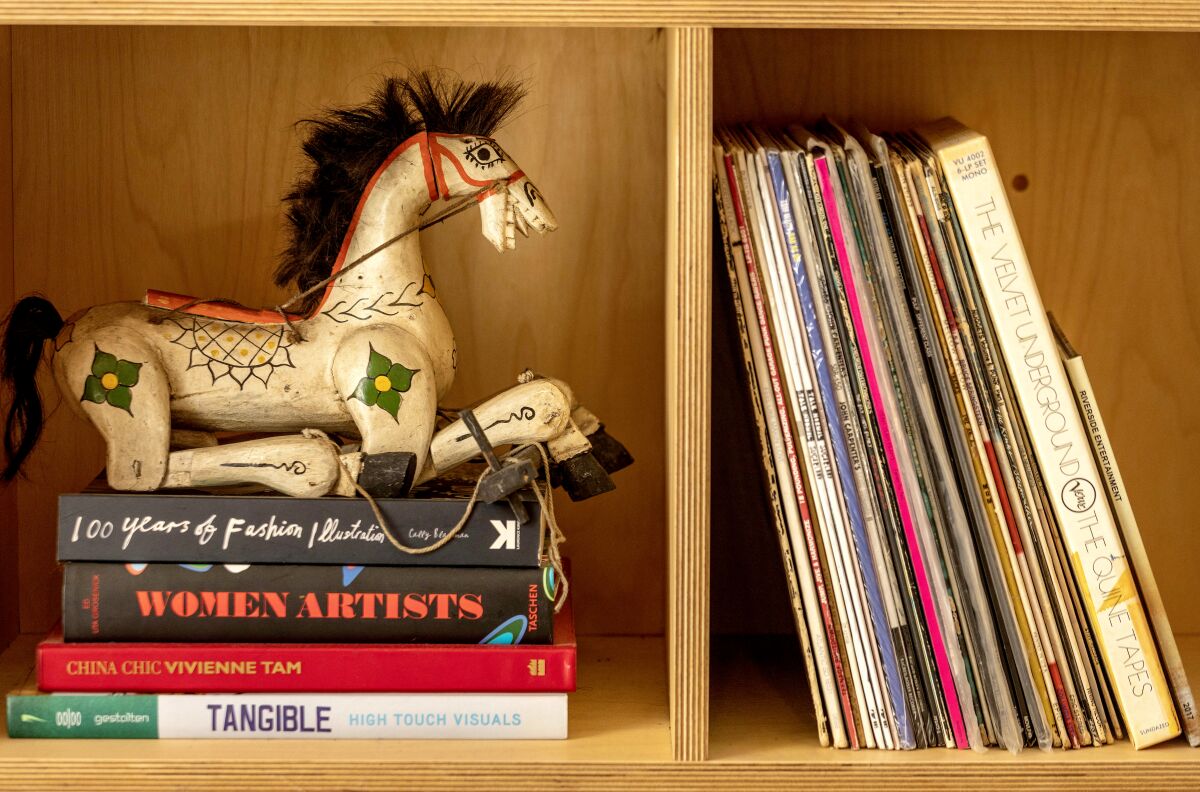Records and books on a bookshelf. 
