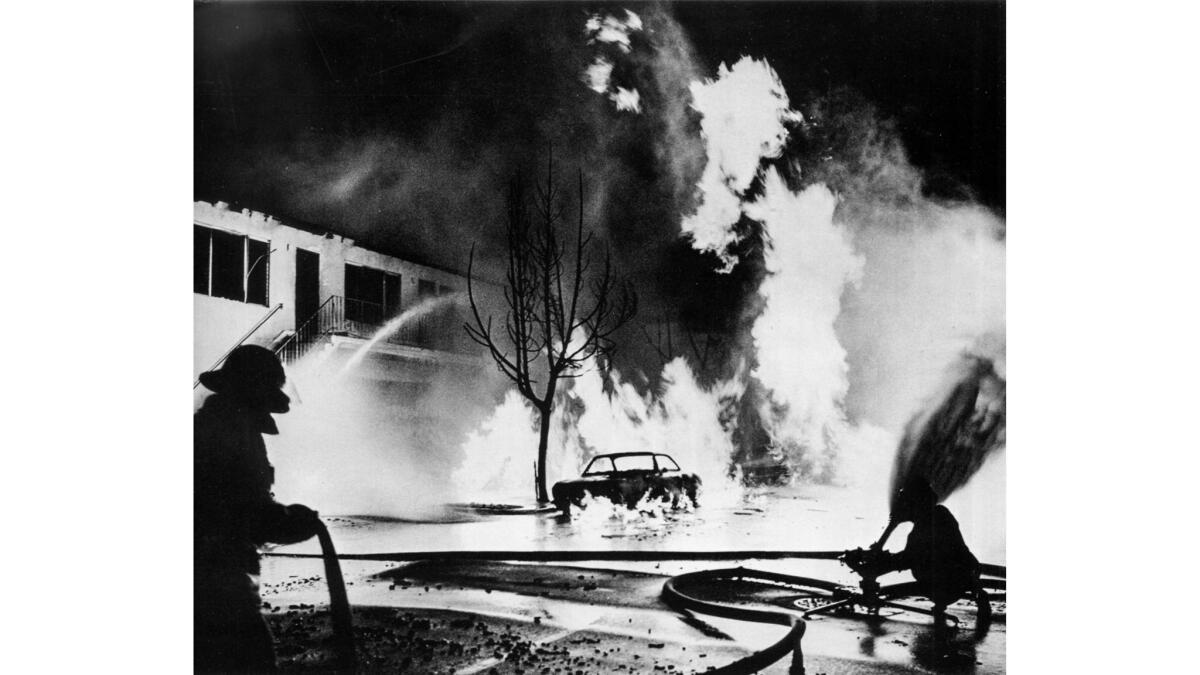 July 4, 1973: Firemen battle blaze set off when a gas main exploded outside an apartment building on Wilton Avenue in Long Beach.